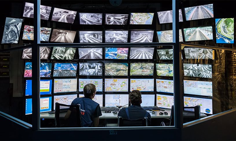 A transit control centre with monitors showing transit operations.