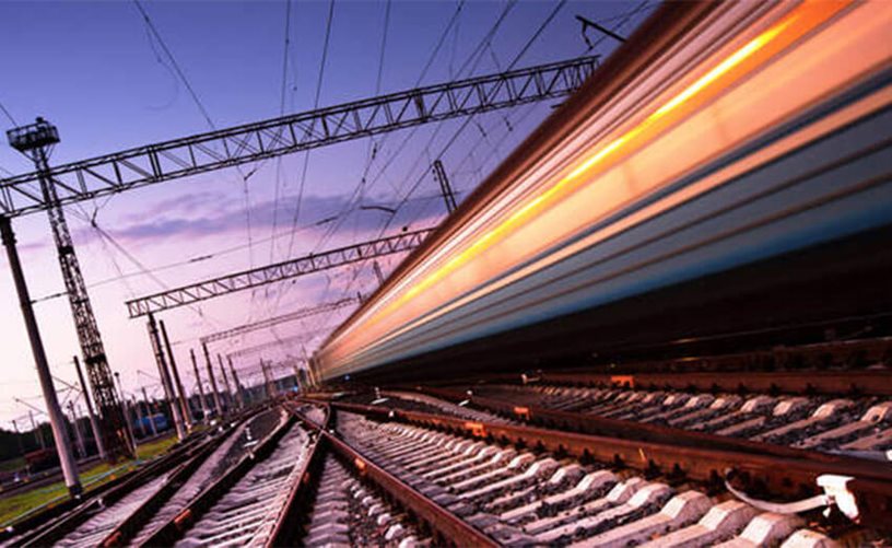 An image of a train travelling fast causing blurring of light.