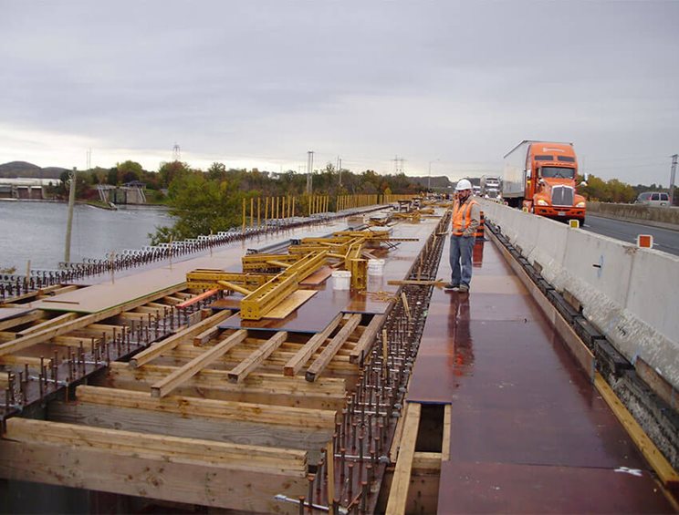 Construction worker doing active bridge construction work.