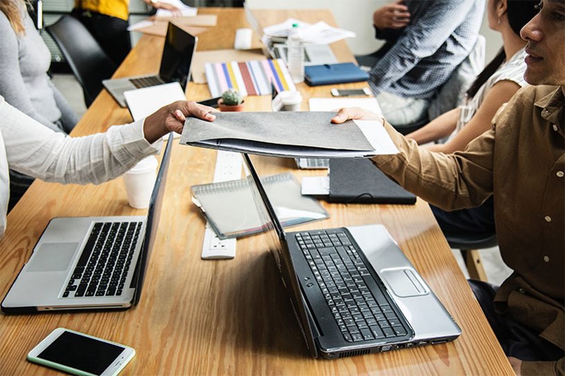 A-M8.jpg Cooperating with coworkers by exchanging documents.