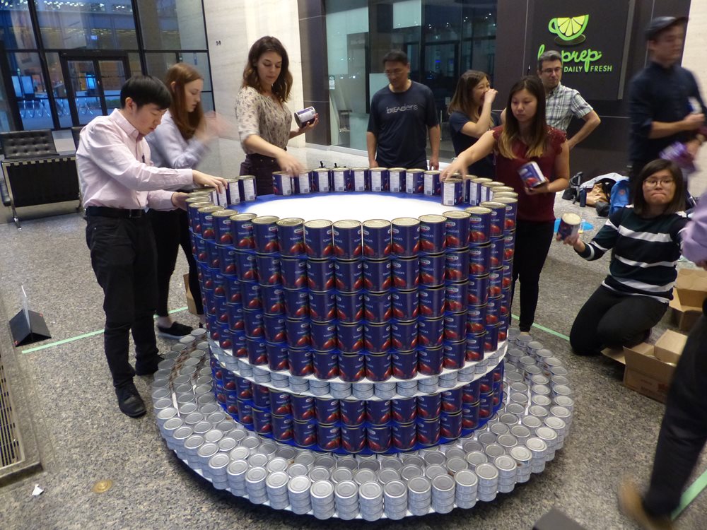 P1050152.JPG LEA team members building their canstruction sculpture.
