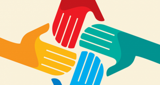 Stock image showing 4 hands gathering together to represent collaboration.
