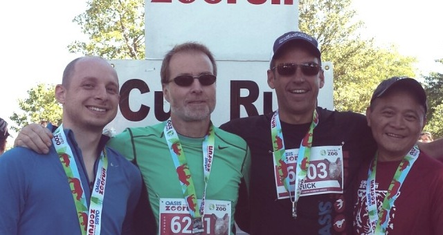 LEA running team members posing with medals after the race.